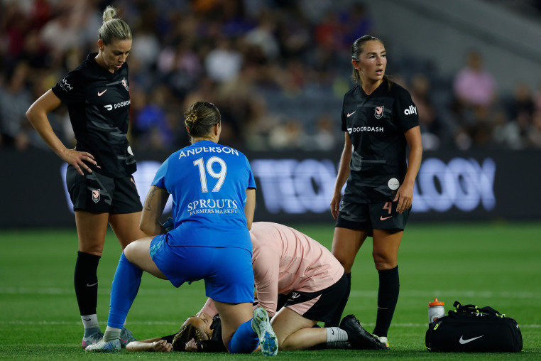 Savy King receives medical attention during the NWSL match